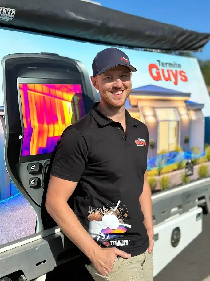 Licensed termite technician Joel from Termite Guys Brisbane standing next to a vehicle with thermal imaging equipment.